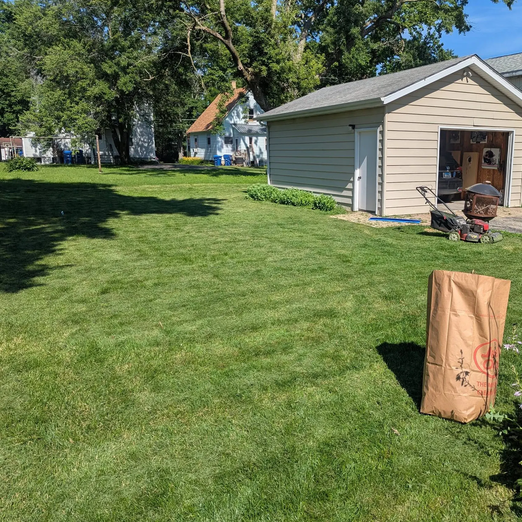 A freshly mowed, trimmed, and edged backyard next to a garage